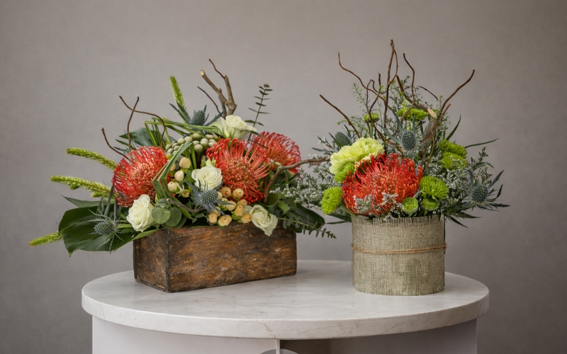 Luxury protea flower arrangements styled in a handcrafted wooden planter and textured pot by House of Flowers Dubai